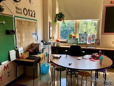 a classroom with desks, chairs and chalkboards on the wall in front of windows