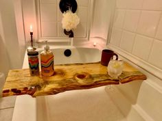 a bathtub with soaps and candles on it