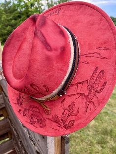 Something in orange pyrography hat. If you love Zach Bryan, you can show your pride and style in this unique hat. Since no two of my designs are the same, yours will be a one of a kind unique design Hand Painted Western Hat Bands For Rodeo, Hand Painted Short Brim Hat For Western-themed Events, Hand Painted Brimmed Hat For Western-themed Events, Hand Painted Adjustable Western Hat, Adjustable Hand Painted Western Hat, Western Hand Painted Hats For Country Events, Hand Painted Flat Brim Hat For Rodeo, Scene Hat, Orange Desert