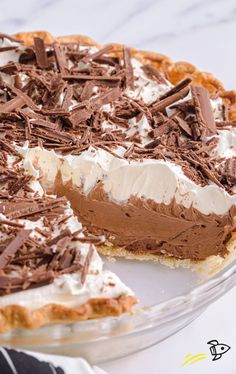 A slice of French Silk Pie with a smooth, creamy chocolate filling, topped with whipped cream and chocolate shavings, served on a dessert plate.