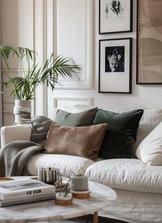 a living room filled with white furniture and lots of pillows on top of the couch