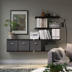 a living room filled with furniture and bookshelves next to a wall mounted painting