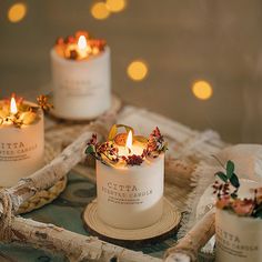 three candles are sitting on top of a table