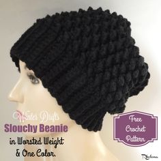 a close up of a mannequin head wearing a black knitted beanie