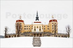 a large building with two towers on top of it in the middle of snow covered ground