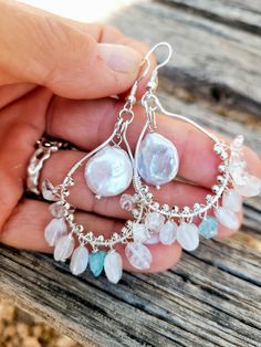 The earrings are made of beautiful natural moonstones dangle  on silver hooks and natural  pearl in the middle of the hook. The blue crystal of apatite between dangling moonstones add the sofisticated look. Complex in color - moonstones and pearls have iridescent colors. Perfect pear of earrings for your wedding gown.  The size of the pearl is 12 mm in diameter.  Length ( with ear hooks) is a little over 2 1/2 inches. The ear wires are silver plated. Please visit my Policies page for shipping and additional information: http://www.etsy.com/shop/BridalBay/policy Arrives in a gift box for easy gift-giving. Bohemian Silver Chandelier Earrings With Pearl Drop, Silver Bohemian Chandelier Earrings With Pearl Drop, Bohemian Silver Dangle Pearl Earrings, Bohemian Sterling Silver Jewelry With Pearl Drop, Bohemian Sterling Silver Pearl Drop Jewelry, Silver Sterling Silver Pearl Earrings With Natural Stones, Silver Moonstone Jewelry With Pearl Drop, Silver Pearl Earrings With Natural Stones In Sterling Silver, Handmade Briolette Pearl Earrings