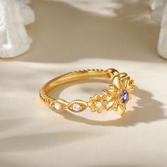 The ring is like a blossoming golden flower, the main stone is translucent and bright, emitting a mysterious purple glow. The gold-colored body of the ring seems to be delicately entwined with petals, like a flower in bloom, radiating warmth and splendor. The sterling silver texture of the ring is light and pure, as if to give it a noble and dignified. Wearing this ring, you can feel the scent of flowers, warmth and beauty. Let it witness every precious moment in your life and bring you happines Silver Texture, Golden Flower, Amethyst Purple, Purple Stones, In Bloom, Precious Moments, A Flower, Diamond White, Sterling Silver Ring