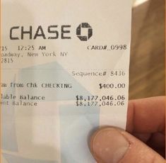 a person holding up a cheque ticket for chase