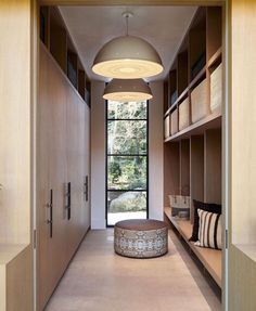 a long hallway with wooden shelves and built - in shelvings on both sides