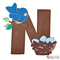 the letter n is made up of wood and has a blue bird perched on it