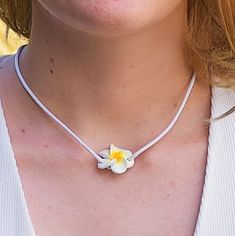 Single Strand 16 inch Pink or White Cord Choker Necklace with matching color Fimo Plumeria Flower slider pendant In stock. Shipped daily from Florida USA Yellow Flower Necklace For The Beach, Yellow Flower Necklace For Beach, White Adjustable Flower Charm Necklace, White Adjustable Charm Necklace With Flower Charm, Adjustable White Charm Necklace, White Flower Charm Necklace For Beach, White Flower Charm Necklace For The Beach, White Flower Shaped Jewelry For Beach, White Flower Charm Jewelry For Beach