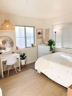 a bedroom with a bed, desk and mirror in it's centerpieces