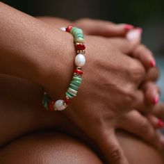 This handmade boho stretch bracelet is meticulously crafted using  natural beauty of green mother-of-pearl heishi discs, 4 pieces of 8 mm real rice pearls, 16 pieces of 14k gold plated hematite, and 8 pieces of red coral stones. Eight pieces of red coral stones are carefully placed between the hematite stones. Each coral stone carries a sense of energy and vitality, adding a touch of passion and warmth to the bracelet. This adjustable statement bracelet is designed for versatility and comfort. It features an adjustable stretch design, allowing it to effortlessly fit a range of wrist sizes. You can use this summer bracelet without removing from your wrist all day long. You can take a shower, swim in the sea or do whatever you like while wearing it. It is not only beautiful but also eco-frie Adjustable Bohemian Jewelry For Holiday, Bohemian Adjustable Bracelets For Holiday, Bohemian Green Jewelry For Holiday, Turquoise Bohemian Stretch Bracelet For Vacation, Green Stackable Jewelry For The Beach, Bohemian Round Bead Bracelets For Holiday, Bohemian Style Adjustable Holiday Bracelets, Handmade Bohemian Bracelets For Holiday, Bohemian Stretch Bracelet For Vacation