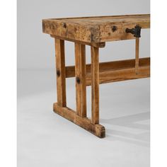 an old wooden table with metal handles on it