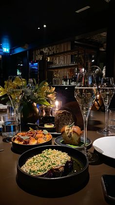 a table topped with plates and glasses filled with food