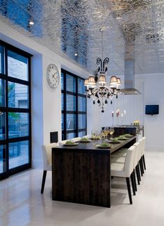 an image of a dining room setting with chandelier and table in the middle