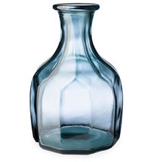 a blue glass vase sitting on top of a white table