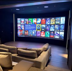 a living room with couches and a large screen