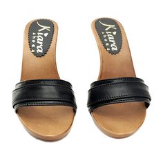 HANDMADE CLOGS Wood-effect clogs with black leather upper. Heel 9 cm. Elegant und comfortable, completely handmade in Italy. Craftsman-made. Size and LENGTH OF THE SHOE ALONG THE CURVE: 35 EU = 4 US = UK3.5 = 23.00 CM 36 EU = 5 US = UK 4 = 23.50 CM 37 EU = 6 US = UK 5 = 24.00 CM 38 EU = 7 US = UK5.5 = 24.50 CM 39 EU = 8 US = UK 6 = 25.00 CM 40 EU = 9 US = UK6.5 = 25.50 CM 41 EU = 10US = UK7.5 = 26.00 CM 42 EU = 11US = UK 8 = 26.50 CM Black Wedge Heel Mules With Removable Insole, Black Closed Toe Sandals With Deep Heel Cup, Black Mules With Wooden Wedge Heel, Black Mules With Wooden Block Heel, Black Clogs With Wooden Wedge Heel, Black High Heel Sandals With Rubber Sole, Black Open Heel Clogs With Reinforced Heel, Black Open Heel Mules With Wooden Heel, Black Open Heel Mules With Leather Sole