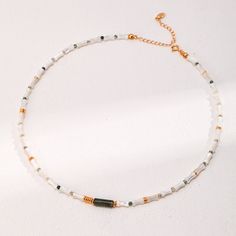 Wear the charm of mother-of-pearl with the organic elegance of bamboo-inspired beads and a Moss Agate bead in the middle. Each segment is crafted with precision, reflecting a dedication to the art of jewelry making and a tribute to natural beauty. Gemstone Type: Moss Agate, Mother-of-Pearl Length: 36.5cm+6cm Material: 18k Gold Plated on Sterling Silver Note: Every pearl is unique. Items may vary from the pictures. Bead Choker, Beaded Choker, Agate Beads, Unique Items, Polish Jewelry, Moss Agate, Natural Pearls, Pearl Jewelry, In The Middle