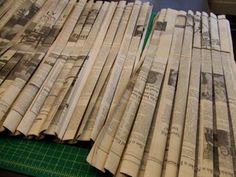 several newspapers laying on top of a cutting board