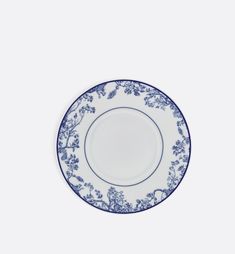 an empty blue and white plate on a white background