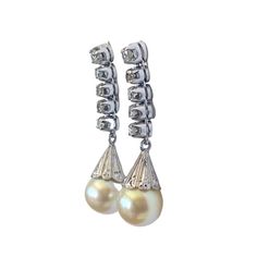 Superb and elegant Ladies Cultured Pearl & Diamond Stud  Dangle Earrings  14K White  Gold each set with 8mm medium grade capped yellowy creme colored cultured pearl, accented with five diamonds. 1 full cut @ 2.4mm 05 points and 4 single cuts @ 1.8mm 02 1/2 points L colors VS clarities ,Gold weight = 4.5 dwt / 6.99grams  1.25" approx long by 0.25" w by 0.50" D amazing in person  thanks Formal Pearl Drop Diamond Earrings In Pear Shape, Formal Diamond White Pearl Dangle Earrings, Classic Pearl Earrings With Diamond Accents For Evening, Classic Dangle Pearl Earrings With Diamonds, Classic Pearl Dangle Earrings, Classic Formal Dangle Pearl Earrings, Classic Formal Diamond Earrings With Bail, Pear-shaped Pearl Drop Diamond Earrings For Formal Events, Formal High Luster Pearl Drop Earrings