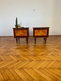 two wooden nightstands sitting on top of a hard wood floor next to each other