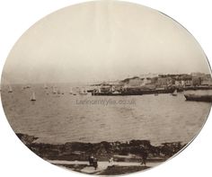 an old black and white photo of boats in the water