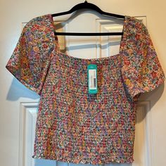 Lush Stella Smocked Crop Blouse Floral. Size L. New With Tags. Trendy Smocked Top With Floral Print For Brunch, Trendy Floral Print Smocked Top For Brunch, Summer Floral Print Smocked Top With Puff Sleeves, Spring Vacation Top With Smocked Cuffs, Pink Floral Print Smocked Top For Vacation, Pink Smocked Back Blouse For Spring, Pink Floral Smocked Top For Spring, Spring Vacation Tops With Smocked Cuffs, Summer Multicolor Smocked Top With Smocked Cuffs