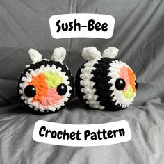 two crocheted stuffed animals sitting next to each other on top of a bed