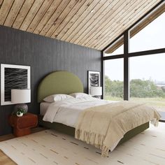 a bedroom with a large bed and wooden ceiling