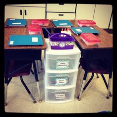 the desks are organized with plastic bins and dividers