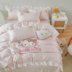 a hello kitty bed set with pink sheets and pillows