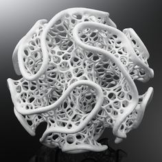 an intricate white sculpture sitting on top of a table