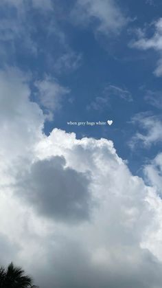 the sky is filled with white clouds and there is a small heart in the center