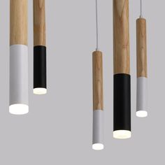 three wooden and white lights hanging from the ceiling