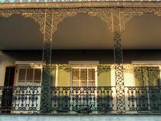 an ornate balcony with wrought iron railings and balconies on the front of a house