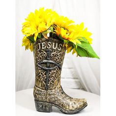 a cowboy boot with yellow flowers in it