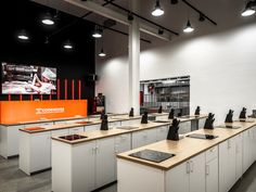 an office with many desks and computers on them in front of a large screen