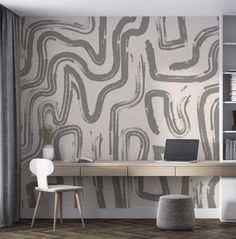 an office with a desk and chair in front of a wallpapered mural that has wavy lines on it