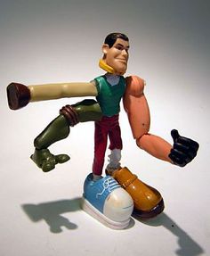 an action figure is posed on top of a shoe