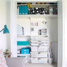 an organized closet with lots of storage and boxes on the bottom shelf is shown in this image