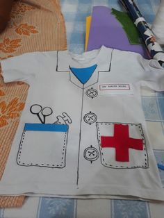 a child's shirt that has been made to look like a doctor uniform with scissors on it