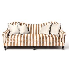 a striped couch with four pillows on it