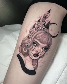 a woman with a crown on her head is depicted in this tattoo design by the artist