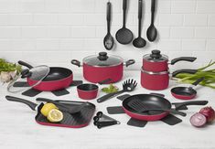 red pots and pans on a white table