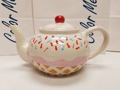 a ceramic teapot with sprinkles on it