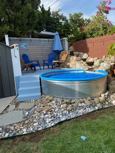 an above ground pool surrounded by rocks and gravel