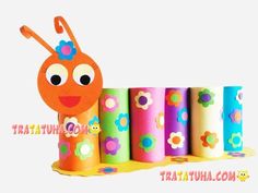 an orange and pink caterpillar surrounded by colorful rolled up toilet paper with the words moola luauata art on it